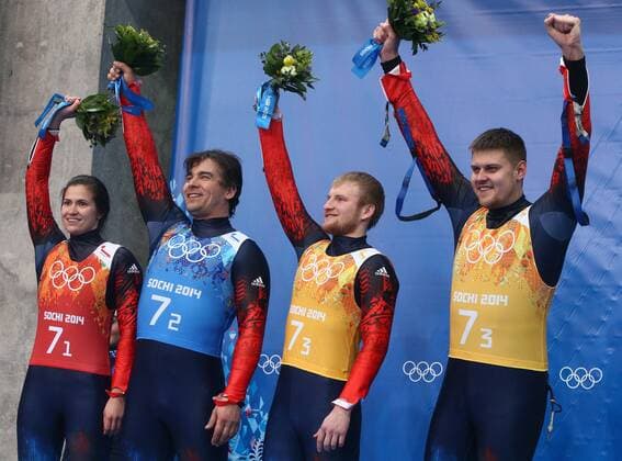 ITAR-TASS: SOCHI, RUSSIA. FEBRUARY 14, 2014. Silver medalists, Russia s Tatyana Ivanova, Albert Demchenko, Vladislav Antonov and Alexander Denisyev (L-R) pose at a flower ceremony following the Luge Team Relay competition at the 22nd Winter Olympic Games in Sochi, at the Sanki Sliding Center.  RE1392CF