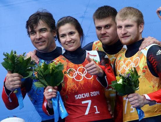 ITAR-TASS: SOCHI, RUSSIA. FEBRUARY 14, 2014. Silver medalists, Russia s Albert Demchenko, Tatyana Ivanova, Alexander Denisyev and Vladislav Antonov (L-R) pose at a flower ceremony following the Luge Team Relay competition at the 22nd Winter Olympic Games in Sochi, at the Sanki Sliding Center.  RE1392D2