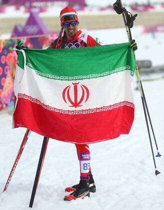 ITAR-TASS: SOCHI, RUSSIA. FEBRUARY 14, 2014. Skier Seyed Sattar Seyd of Iran holds his national flag after the men s cross-country 15 km classic event at the Laura Ski Centre at the 22nd Winter Olympic Games.  premiumd kurios Aufmacher RE139461