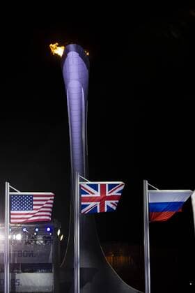 15.02.2014 Sochi, Krasnodar Krai, Russia. The Union Flag flies high for Lizzy YARNOLD (GBR) in front of the Olympic flame during the Medal Ceremony for the Women s Skeleton at the Sochi Medals Plaza, Coastal Cluster - XXII Olympic Winter Games xCraigxMercerx  ActionPlus11498476