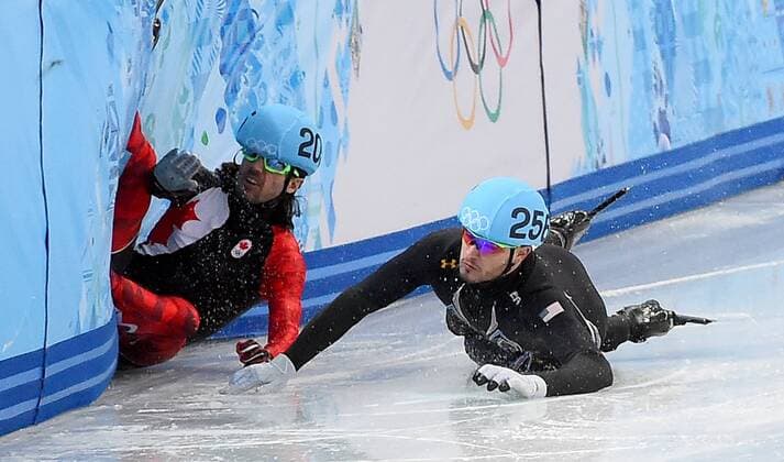 Feb. 15, 2014 - Sochi, RUS - USA s Eduardo Alvariz (256) and Canada s Charles Jamelin (205) collide and fall during the Men s 1000 meter quarterfinal race at the Iceberg Skating Palace during the Winter Olympics in Sochi, Russia, Saturday, February 15, 2014. Men s 1000 meter Short Track Speed Skating - ZUMAm67