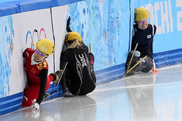 Feb. 15, 2014 - Sochi, RUS - China s Alang Ki, (111), left, USA s Emily Scott (155), center, and Korea s Alang Kim (136), right, crash into the wall after colliding as they came out of a turn during the Ladies 1500 meter finals race at the Iceberg Skating Palace during the Winter Olympics in Sochi, Russia, Saturday, February 15, 2014. Ladies 1500 meter Short Track Speed Skating - ZUMAm67