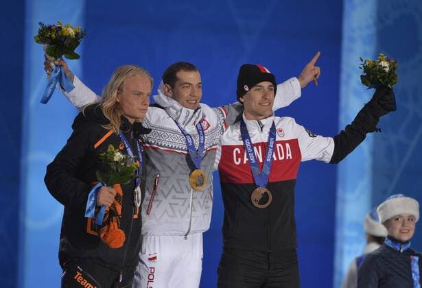 The Netherlands Koen Verweij, Poland s Zbigniew Brodka and Canada s Denny Morrison celebrate their silver, gold and bronze medals respectively during the victory ceremony for men s speed skating 1500M at the Sochi 2014 Winter Olympics on February 16, 2014 in Sochi, Russia.  OLY20140216740