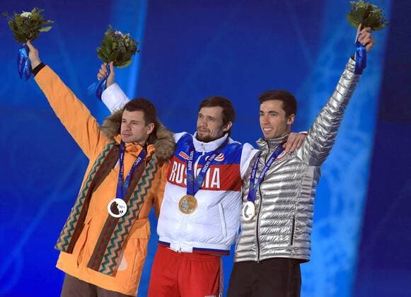 ITAR-TASS: SOCHI, RUSSIA. FEBRUARY 16, 2014. US Matthew Antoine (Bronze), Russian Alexander Tretiakov (Gold) and Latvian Martins Dukurs (Silver), from left to right, at a victory ceremony for the men s skeleton event at the Sochi 2014 Winter Olympic Games, at Medals Plaza.  RE139B43