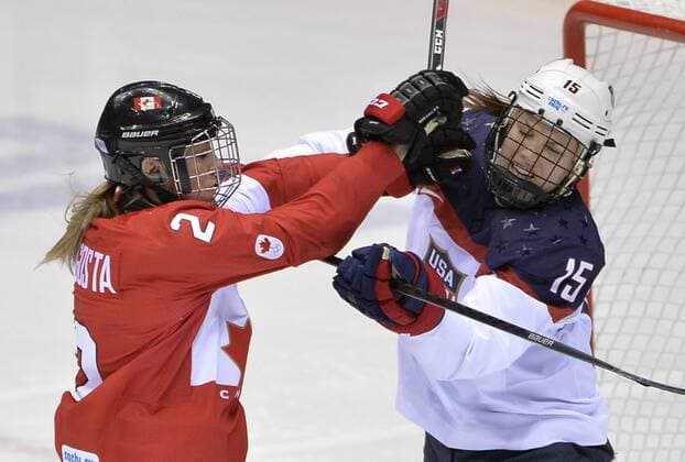 Canada s Meghan Agosta (L) shoves United States Anne Schleper during the second period of the women s gold medal ice hockey game at the Sochi 2014 Winter Olympics on February 20, 2014 in Sochi, Russia.  OLY20140220134