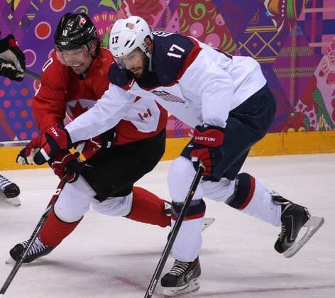 Feb. 21, 2014 - Sochi, RUS - Canada forward Patrick Sharp (10) and USA forward Ryan Kesler (17) fight for the puck in the first period of a men s hockey semifinal at Bolshoy Ice Dome during the Winter Olympics in Sochi, Russia, Friday, Feb. 21, 2014. USA vs Canada Hockey - ZUMAm67
