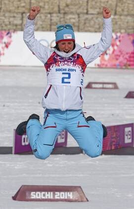 ITAR-TASS: SOCHI, RUSSIA. FEBRUARY 22, 2014. Norway s Marit BjÃ¶rgen celebrates winning a gold medal in the women s cross-country skiing 30km mass start free event at the 22nd Winter Olympic Games in Sochi, at the Laura Ski Center.  RE13AA0B