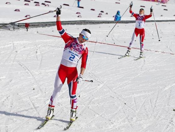ITAR-TASS: SOCHI, RUSSIA. FEBRUARY 22, 2014. Gold medalist, Norway s Marit Bjoergen (front) and Silver medalist, Norway s Therese Johaug react after competing in the women s cross-country skiing 30km mass start free event at the 22nd Winter Olympic Games in Sochi, at the Laura Ski Center.  RE13AA36