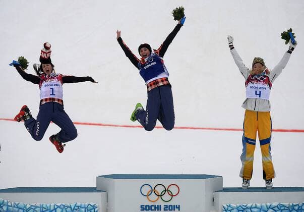 Feb. 21, 2014 - Sochi, Sochi, Russia - Canada s Marielle Thompson of Whistler, BC and Kelsey Serwa of Kelowna, BC jump of the podium after winning the gold and silver medals in Ski Cross at the Rosa Khutor Extreme Park in Sochi, Russia, on Friday February 21, also on the podium Anna Holmlund of Sweden 2014. Didier Debusschere Journal de Quebec Agence QMI OLY2014 Sochi Olympics - ZUMAq06