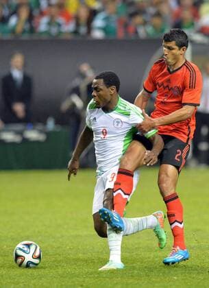 March 5, 2014 - Atlanta, GA, USA - Nigeria s Emmanuel Emenike and Mexico Francisco Javier Rodriguez (2) battle for the ball during the second half of an international friendly at the Georgia Dome in Atlanta on Wednesday, March 5, 2014. Nigeria vs. Mexico - ZUMAm67