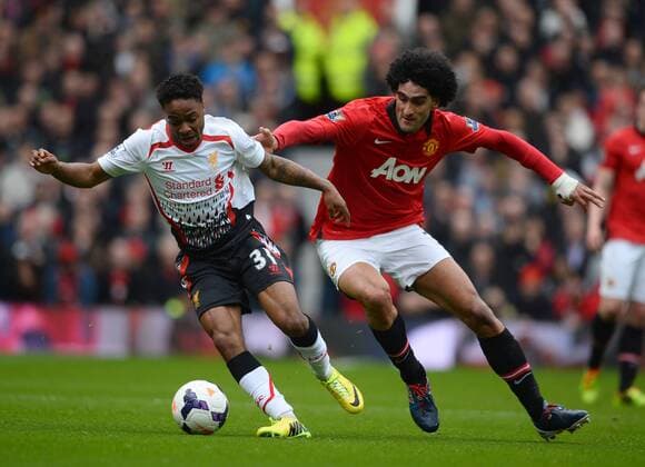 Raheem Sterling of Liverpool tussles with Mauroane Fellaini of Manchester United - Barclays Premier League - Manchester Utd vs Liverpool - Old Trafford Stadium - Manchester - England - 16th March 2014 - Pic Simon Bellis Sportimage EDITORIAL USE ONLY. No use with unauthorised audio, video, data, fixture lists, club league logos or live services. Online in-match use limited to 120 images, no video emulation. No use in betting, games or single club league player publications.