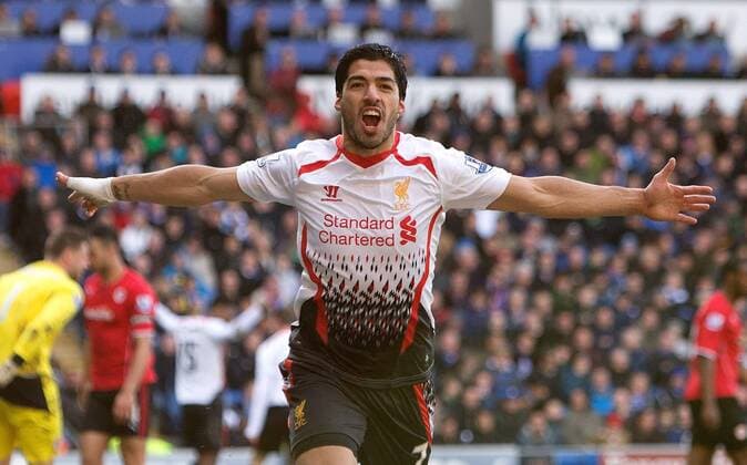 Luis Suarez of Liverpool celebrates scoring his sides fourth goal - Barclays Premier League - Cardiff City vs. FC Liverpool - Cardiff City Stadium - Cardiff - Wales - 22nd March 2014 - EDITORIAL USE ONLY. No use with unauthorised audio, video, data, fixture lists, club league logos or live services. Online in-match use limited to 120 images, no video emulation. No use in betting, games or single club league player publications.