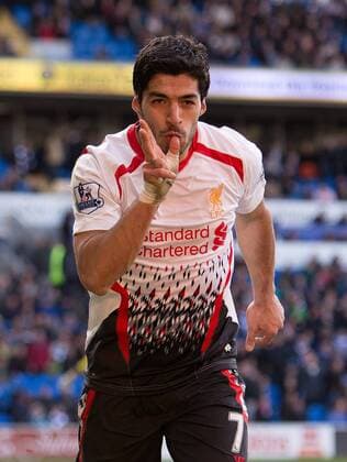 Luis Suarez of Liverpool celebrates scoring his sides sixth goal - Barclays Premier League - Cardiff City vs. FC Liverpool - Cardiff City Stadium - Cardiff - Wales - 22nd March 2014 - EDITORIAL USE ONLY. No use with unauthorised audio, video, data, fixture lists, club league logos or live services. Online in-match use limited to 120 images, no video emulation. No use in betting, games or single club league player publications.