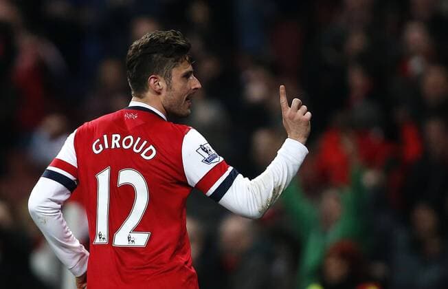 Olivier Giroud of Arsenal celebrates scoring during the Barclays Premier League match between Arsenal and Swansea City at Emirates Stadium in London, Britain on Mar. 25, 2014. The match ended with a 2-2 draw. (Xinhua Wang Lili) FOR EDITORIAL USE ONLY. NOT FOR SALE FOR MARKETING OR ADVERTISING CAMPAIGNS. NO USE WITH UNAUTHORIZED AUDIO, VIDEO, DATA, FIXTURE LISTS, CLUB LEAGUE LOGOS OR LIVE SERVICES. ONLINE IN-MATCH USE LIMITED TO 45 IMAGES, NO VIDEO EMULATION. NO USE IN BETTING, GAMES OR SINGLE CLUB LEAGUE PLAYER PUBLICATIONS. (SP)BRITAIN-LONDON-SOCCER-PREMIER LEAGUE-ARSENAL VS SWANSEA CITY