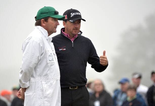 Graeme McDowell talks to his caddie Ken Comboy during a practice round prior to the Masters golf tournament at Augusta National Golf Club in Augusta, George, April 7, 2014.  AUG20140407323