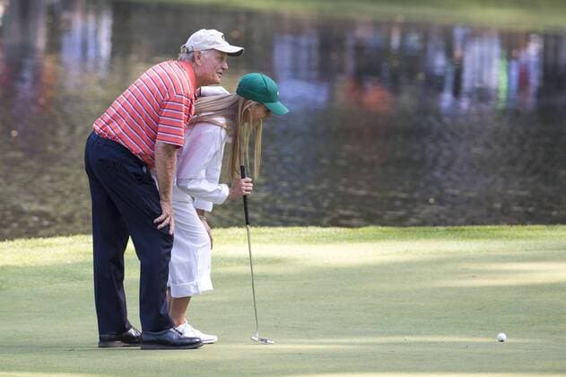 Jack Nicklaus and his granddaughter Christie line up a putt on the ninth green during the Par 3 Contest during the Masters Tournament at Augusta National Golf Club in Augusta, Georgia, April 8, 2014.  AUG20140409339
