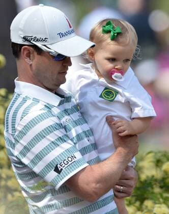 Zack Johnson carries his daughter Abby Jane during the Par 3 Contest during the Masters Tournament at Augusta National Golf Club in Augusta, Georgia, April 8, 2014.  AUG20140409341