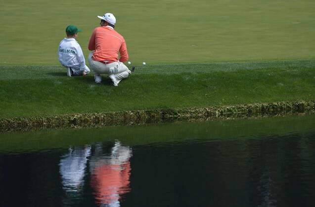 Trevor Immelman and his son Jacob line up a putt on the ninth green during the Par 3 Contest during the Masters Tournament at Augusta National Golf Club in Augusta, Georgia, April 8, 2014.  AUG20140409399