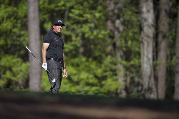 Phil Mickelson waits to hit on the 11th fairway during the first round of the 2014 Masters Tournament at Augusta National Golf Club in Augusta, Georgia, April 10, 2014.  AUG20140410350