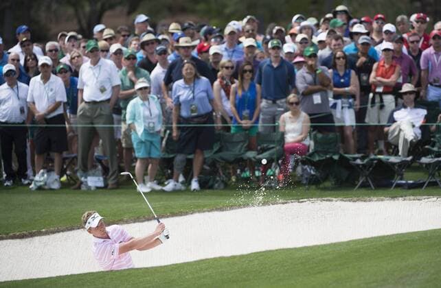 Luke Donald hits out of a bunker on the 18th hole during the second round of the 2014 Masters Tournament at Augusta National Golf Club in Augusta, Georgia, April 11, 2014.  AUG20140411323