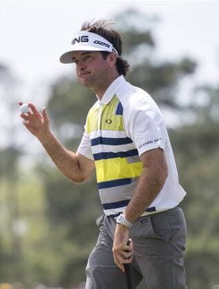 Bubba Watson acknowledges the gallery after putting on the 17th green during the second round of the 2014 Masters Tournament at Augusta National Golf Club in Augusta, Georgia, April 11, 2014. Watson finished seven under par.  AUG20140411343