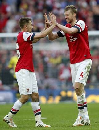 Per Mertesacker (R) of Arsenal celebrates scoring with Aaron Ramsey during FA Cup semifinal match between Arsenal and Wigan Athletic at Wembley Stadium in London, Britain, on April 12, 2014. Arsenal advanced to the final with winning 4-2 on penalties after a 1-1 draw. (Xinhua Wang Lili) FOR EDITORIAL USE ONLY. NOT FOR SALE FOR MARKETING OR ADVERTISING CAMPAIGNS. NO USE WITH UNAUTHORIZED AUDIO, VIDEO, DATA, FIXTURE LISTS, CLUBLEAGUE LOGOS OR LIVE SERVICES. ONLINE IN-MATCH USE LIMITED TO 45 IMAGES, NO VIDEO EMULATION. NO USE IN BETTING, GAMES OR SINGLE CLUBLEAGUEPLAYER PUBLICATIONS. (SP)BRITAIN-LONDON-SOCCER-FA CUP-ARSENAL VS WIGAN 