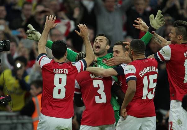 FA Cup SemiFinal - FC Arsenal London v Wigan Athletic . . Wembley, London, UK . . 12.04.2014 Lukasz Fabianski (A) is mobbed after his saves helped to win the penalty shoot-out. 