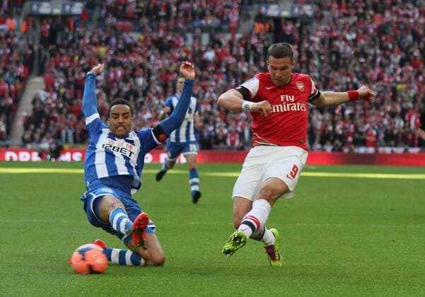 FA Cup SemiFinal - FC Arsenal London v Wigan Athletic . . Wembley, London, UK . . 12.04.2014 James Perch (WA) Lukas Podolski (A) 