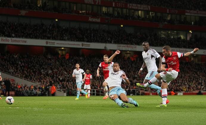 Arsenal s Lukas Podolski scoring his sides opening goal Arsenal vs West Ham United- Barclays Premier League - Emirates Stadium - London - England - 15 04 2014 - Pic David Klein Sportimage EDITORIAL USE ONLY. No use with unauthorised audio, video, data, fixture lists, club league logos or live services. Online in-match use limited to 120 images, no video emulation. No use in betting, games or single club league player publications.