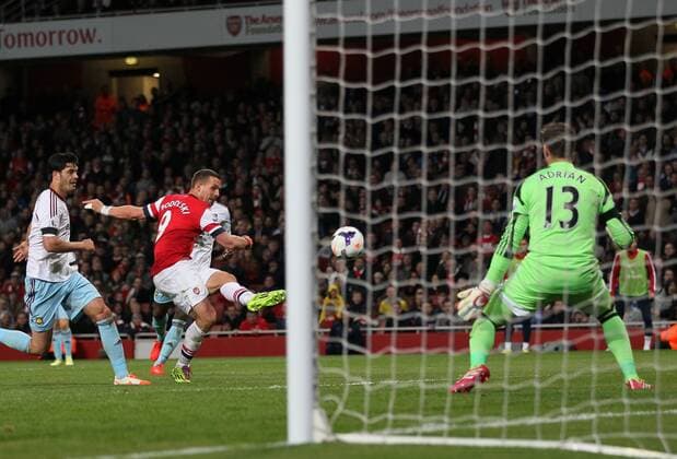 Arsenal s Lukas Podolski scoring his sides third goal Arsenal vs West Ham United- Barclays Premier League - Emirates Stadium - London - England - 15 04 2014 - Pic David Klein Sportimage EDITORIAL USE ONLY. No use with unauthorised audio, video, data, fixture lists, club league logos or live services. Online in-match use limited to 120 images, no video emulation. No use in betting, games or single club league player publications.