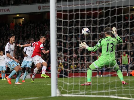 Arsenal s Lukas Podolski scoring his sides third goal Arsenal vs West Ham United- Barclays Premier League - Emirates Stadium - London - England - 15 04 2014 - Pic David Klein Sportimage EDITORIAL USE ONLY. No use with unauthorised audio, video, data, fixture lists, club league logos or live services. Online in-match use limited to 120 images, no video emulation. No use in betting, games or single club league player publications.