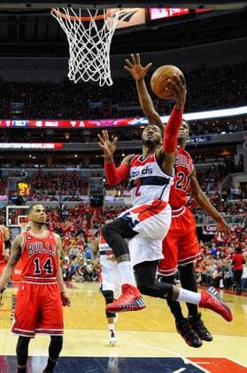 Washington Wizards guard John Wall (2) dunks the ball against Chicago Bulls guard Jimmy Butler (21)in the first half of the third game of the first round of playoffs at the Verizon Center in Washington, D.C. on April 25, 2014 where the Chicago Bulls defeated the Washington Wizards 100-97.  WAG2014042516