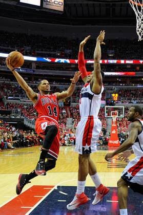 Chicago Bulls guard D.J. Augustin (14) scores on a fast break against Washington Wizards guard Bradley Beal (3) in the second half of the third game of the first round of playoffs at the Verizon Center in Washington, D.C. on April 25, 2014 where the Chicago Bulls defeated the Washington Wizards 100-97.  WAG2014042517