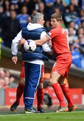 Chelsea manager Jose Mourinho holds the match ball away from Steven Gerrard of Liverpool - at Anfield Stadium - Liverpool FC - England - 27th April 2014 - EDITORIAL USE ONLY. No use with unauthorised audio, video, data, fixture lists, club league logos or live services. Online in-match use limited to 120 images, no video emulation. No use in betting, games or single club league player publications.