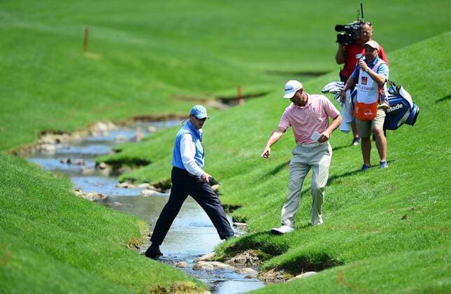 May 2, 2014 - Charlotte, NC, USA - Shawn Stefani points as he and a golf official discuss the golfer s next move, after Stefani hit the ball in the creek on the 18th fairway during the second day of the Wells Fargo Championship at Quail Hollow Club in Charlotte, N.C., Friday, May 2, 2014. Wells Fargo Championship - ZUMAm67