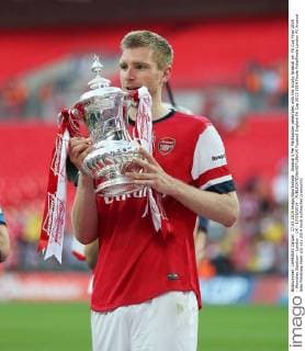 Arsenal s Per Mertsacker celebrates with the trophy Arsenal vs- FA Cup Final 2014 - Wembley Stadium - London - UK - 17 05 2014 - EDITORIAL USE ONLY. No use with unauthorised audio, video, data, fixture lists, club league logos or live services. Online in-match use limited to 120 images, no video emulation. No use in betting, games or single club league player publications.