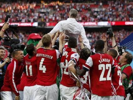 Arsenal manager Arsene Wenger is thrown by the players after FA Cup final between Arsenal and Hull City at Wembley Stadium in London, Britain, on May 17, 2014. Arsenal ended nine-year wait for a trophy by beating Hull City with 3-2. (Xinhua Wang Lili) FOR EDITORIAL USE ONLY. NOT FOR SALE FOR MARKETING OR ADVERTISING CAMPAIGNS. NO USE WITH UNAUTHORIZED AUDIO, VIDEO, DATA, FIXTURE LISTS, CLUBLEAGUE LOGOS OR LIVE SERVICES. ONLINE IN-MATCH USE LIMITED TO 45 IMAGES, NO VIDEO EMULATION. NO USE IN BETTING, GAMES OR SINGLE CLUBLEAGUEPLAYER PUBLICATIONS. (SP)BRITAIN-LONDON-SOCCER-FA CUP-FINAL-ARSENAL VS HULL CITY 