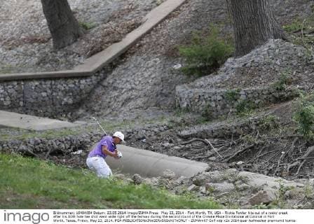 May 23, 2014 - Fort Worth, TX, USA - Rickie Fowler hits out of a rocky creek after his 10th hole tee shot went wide right off the fairway during the second round of the Crowne Plaza Invitational at Colonial in Fort Worth, Texas, Friday, May 23, 2014. PGA - ZUMAm67