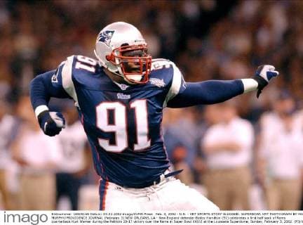 Feb. 3, 2002 - U.S. - KRT SPORTS STORY SLUGGED: SUPERBOWL KRT PHOTOGRAPH BY MARY MURPHY PROVIDENCE JOURNAL (February 3) NEW ORLEANS, LA - New England defender Bobby Hamilton (91) celebrates a first half sack of Rams quarterback Kurt Warner during the Patriots 20-17 victory over the Rams in Super Bowl XXXVI at the Louisiana Superdome, Sunday, February 3, 2002. (PJ) NC KD BL 2002 (Horiz) (Digital image) (smd) -- NO MAGS, NO SALES News Archive - Feb. 3, 2002 - ZUMAm67