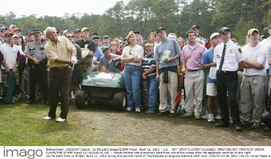 April 12, 2002 - U.S. - KRT SPORTS STORY SLUGGED: MASTERS KRT PHOTO BY JASON CLARK THE STAMP (April 12) AUGUSTA, GA -- Arnold Palmer hits a recovery shot from out of the crowd after his approach went far to the right on the ninth hole on Friday, April 12, 2002 during the second round of The Masters at Augusta National Golf Club. (CS) NC KD BL 2002 (Horiz) (mvw) News Archive - April 12, 2002 - ZUMAm67