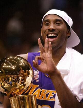 June 12, 2002 - STAMP, U.S. - NO MAGS, NO SALES -- KRT SPORTS STORY SLUGGED: LAKERS-NETS KRT PHOTO BY CHRIS CARLSON ORANGE COUNTY REGISTER (June 12) EAST RUTHERFORD, NJ -- While holding the trophy Los Angeles Kobe Bryant (8) signals the Laker s threepeat after sweeping the New Jersey Nets to win their third straight NBA Basketball Herren USA Championship on Wednesday, June 12, 2002, at the Meadowlands, in East Rutherford, New Jersey. (OC) NC KD 2002 (Vert) (Digital image) (mvw) News Archive - June 12, 2002 - ZUMAm67