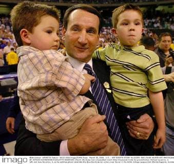 March 28, 2004 - USA - Duke men s basketball coach Mike Krzyzewski holds his grandchildren Michael Savarino, 3, left, and Joey Savarino, 4, as he watches player celebrate the Blue Devils 66-62 victory over Xavier in the NCAA College League USA Atlanta Regional, Sunday, March 28, 2004. (smd) 2004. News Archive - March 28, 2004 - ZUMAm67