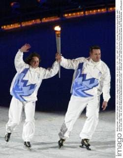 Feb. 8, 2002 - U.S. - SALT LAKE CITY, UT-- Former Olympians Bonnie Blair (left) and Dan Jansen skate with the torch toward the Olympic cauldron at the Winter Olympic Opening Ceremony Friday February 8, 2002 in Salt Lake City, Utah. (DA) - Feb. 8, 2002 - ZUMAm67