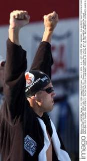 July 11, 2004 - U.S. - KRT SPORTS STORY SLUGGED: OLY-SWIM KRT PHOTOGRAPH BY KARL MONDON CONTRA COSTA TIMES (July 11) LONG BEACH, CA -- Wearing a boxer s robe, Gary Hall, Jr. gives a clenched fist salute to the crowd before the 100m Freestyle finals at the U.S. Olympic team trials in Long Beach, California, on Sunday, July 11, 2004. Hall placed third, and failed to qualify in the event for the Olympics. But he still made the Olympic team as a relay swimmer. (cdm) 2004 News Archive - July 11, 2004 - ZUMAm67