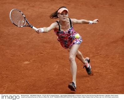 Agnieszka Radwanska of Poland returns the ball during the Women s Singles third round match at Roland Garros in Paris on May 30, 2014. 