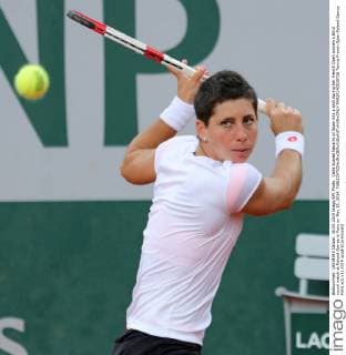 Carla Suarez Navarro of Spain hits a shot during her French Open women s third round match at Roland Garros in Paris on May 30, 2014.  PAR20140530726