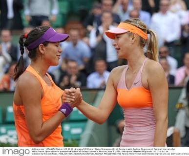 Maria Sharapova (R) of Russia meets Garbine Muguruza of Spain at the net after their French Open women s quarterfinal match at Roland Garros in Paris on June 3, 2014. Sharapova defeated Muguruza 1-6, 7-5, 6-1 to advance to the semifinals.  PAR20140603721
