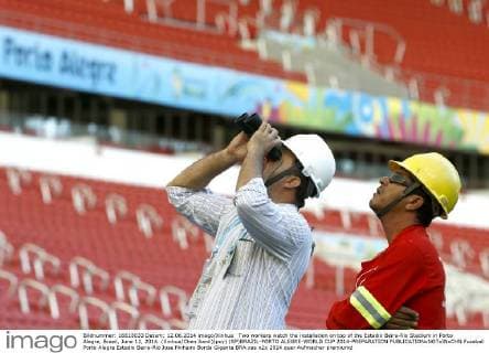 Two workers watch the installation on top of the Estadio Beira-Rio Stadium in Porto Alegre, Brazil, June 12, 2014. (Xinhua Chen Jianli)(pcy) (SP)BRAZIL-PORTO ALEGRE-WORLD CUP 2014-PREPARATION 