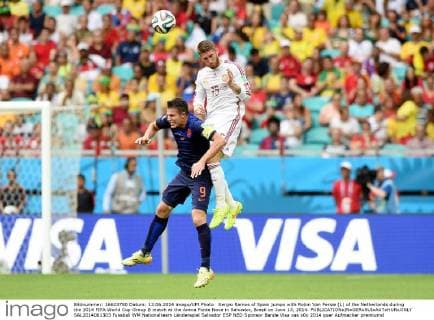 Sergio Ramos of Spain jumps with Robin Van Persie (L) of the Netherlands during the 2014 FIFA World Cup Group B match at the Arena Fonte Nova in Salvador, Brazil on June 13, 2014.  SAL2014061303