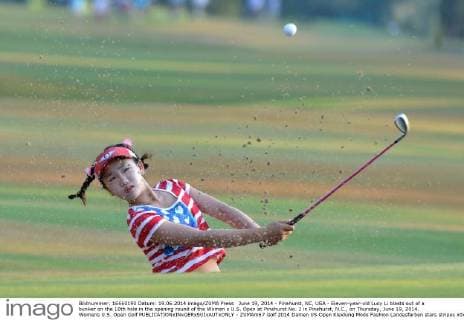June 19, 2014 - Pinehurst, NC, USA - Eleven-year-old Lucy Li blasts out of a bunker on the 10th hole in the opening round of the Women s U.S. Open at Pinehurst No. 2 in Pinehurst, N.C., on Thursday, June 19, 2014. Womens U.S. Open Golf - ZUMAm67